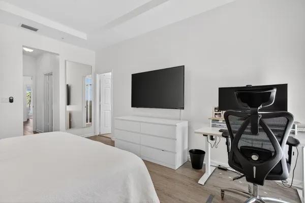 a bedroom with a bed and a flat screen tv