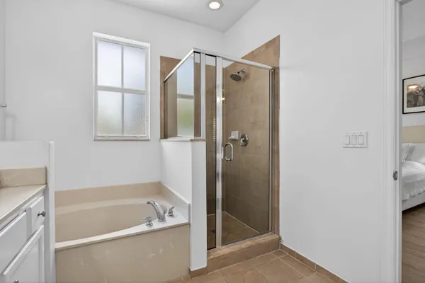 a bathroom with a tub shower and sink