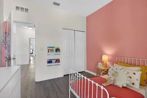 a bedroom with furniture and a book shelf