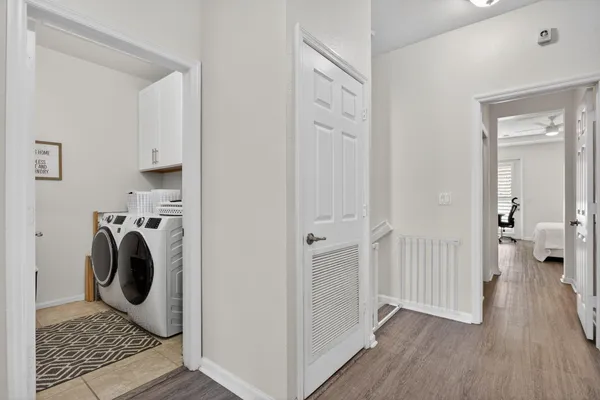 a view of a bedroom with washer and dryer