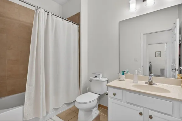 a bathroom with a sink a toilet and shower curtain