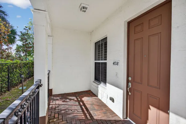 a view of a hallway with wooden floor and fence