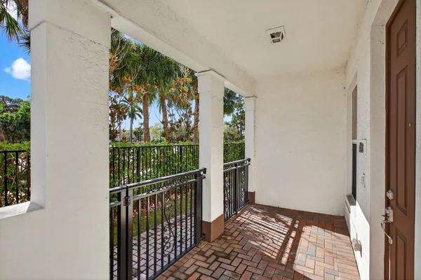 a view of a room with wooden floor and windows