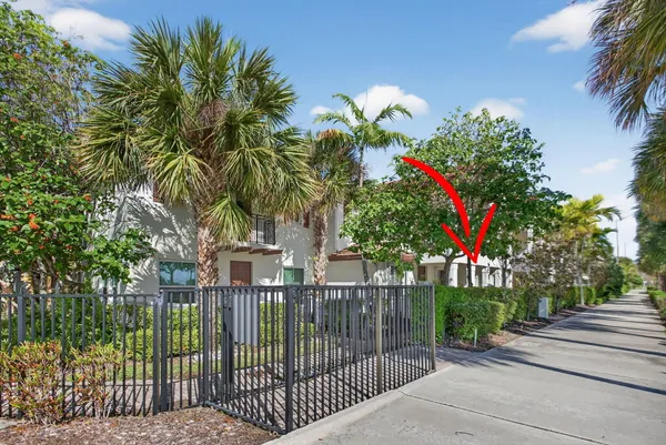 a green field with trees in front of it
