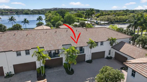 an aerial view of a house with a yard and furniture