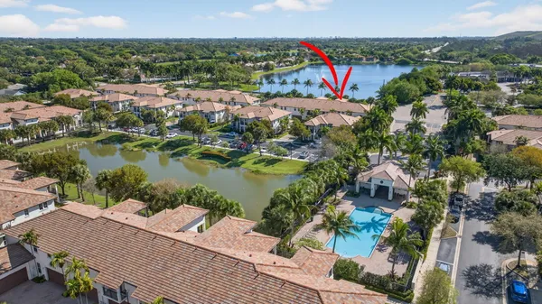 an aerial view of residential houses with outdoor space and river