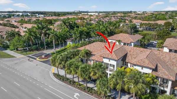 an aerial view of a house with a yard and lake view