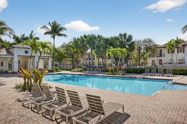 a view of a swimming pool with a table and chairs