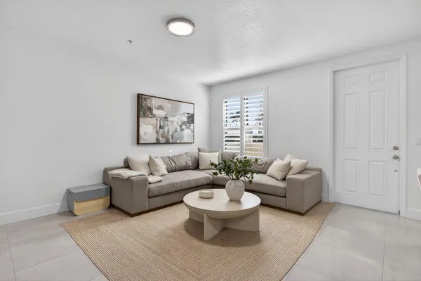 a living room with furniture and a large window