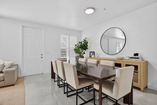 a view of a dining room with furniture and a mirror