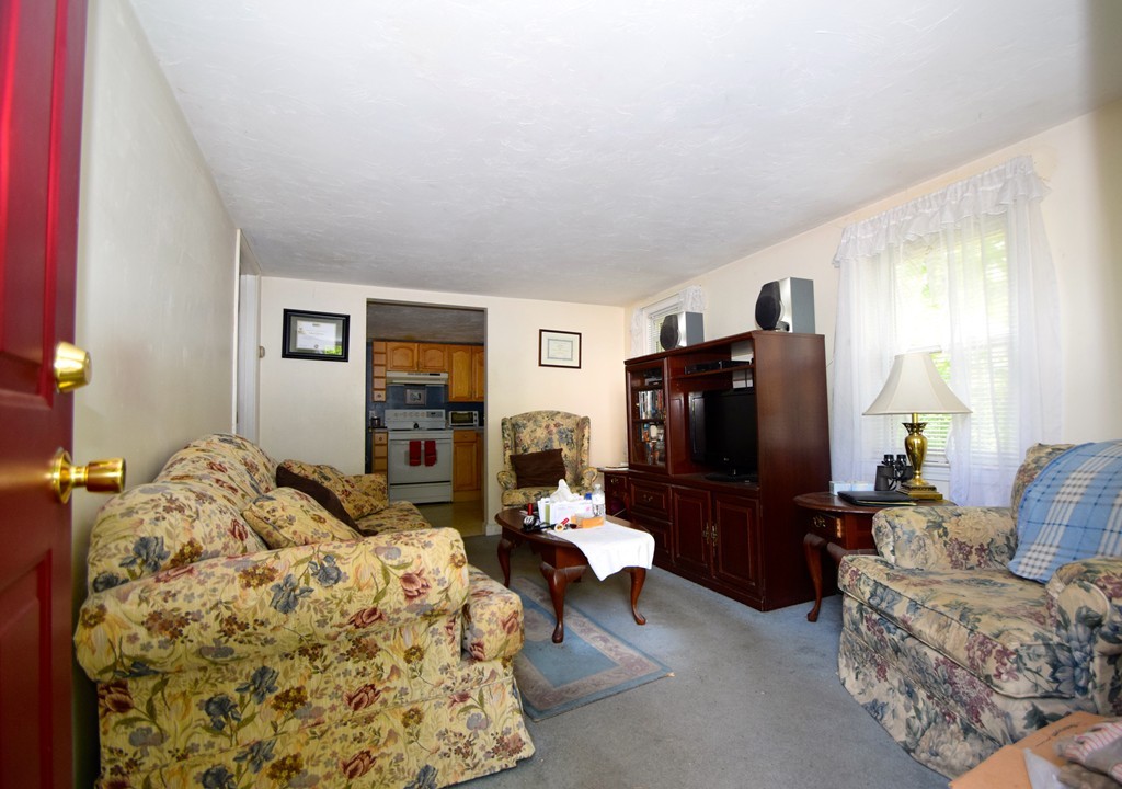 9 English Road Holbrook, MA 02343 - Photo 2 of 15 a living room with furniture and a flat screen tv