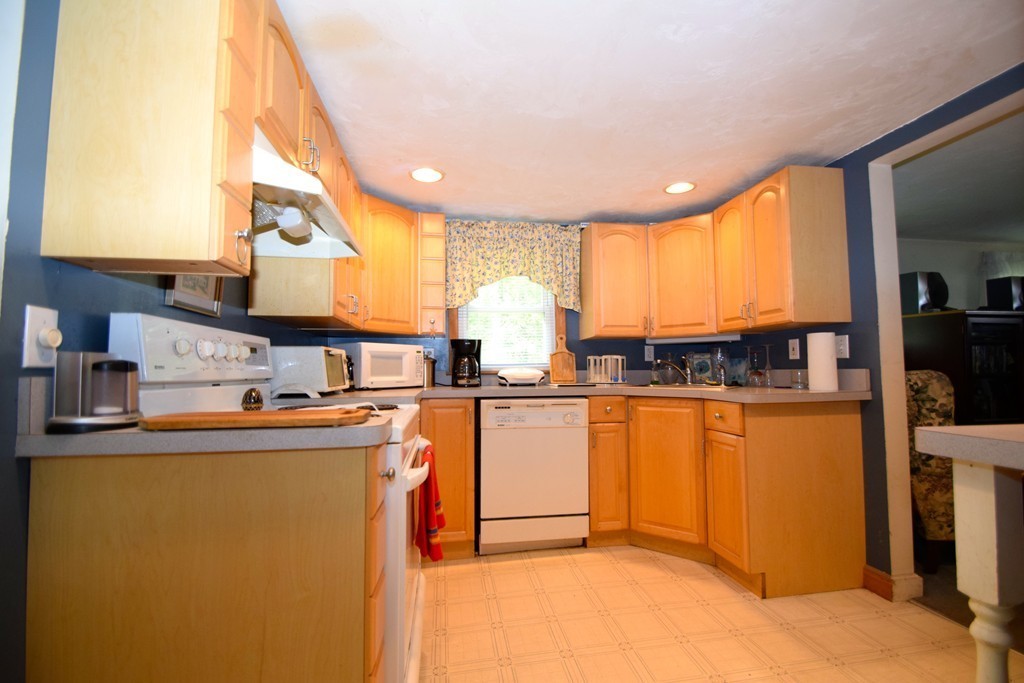 9 English Road Holbrook, MA 02343 - Photo 4 of 15 a kitchen with stainless steel appliances granite countertop a sink a stove and a refrigerator