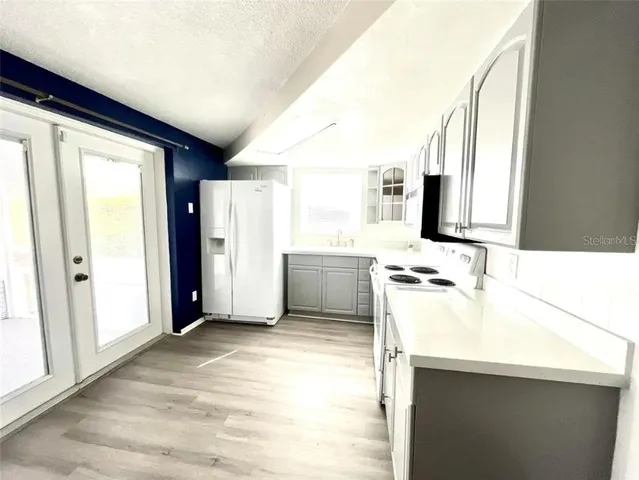 a kitchen with a sink appliances and cabinets