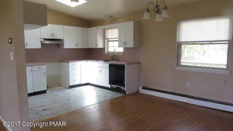 1073 State Road Effort, PA 18330 - Photo 7 of 10 a kitchen with stainless steel appliances granite countertop a stove a sink and a microwave