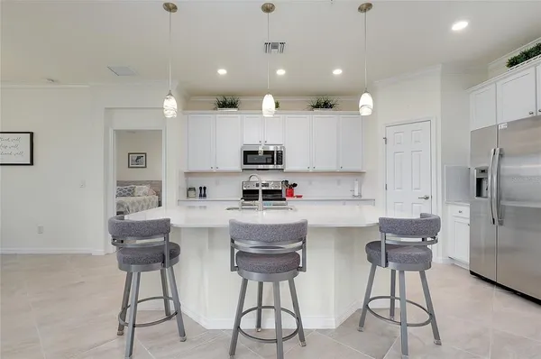a kitchen with stainless steel appliances a sink stove and cabinets