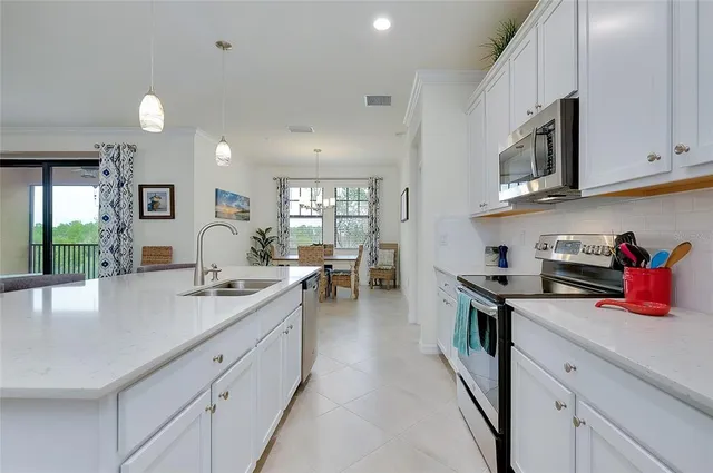 a kitchen with white cabinets and white appliances