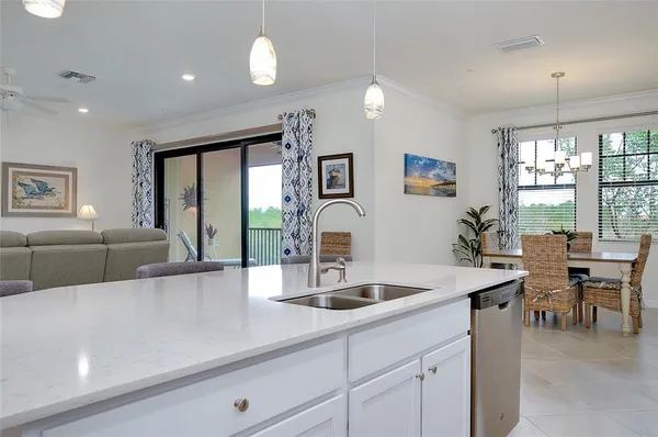 a dining room with furniture a chandelier and window