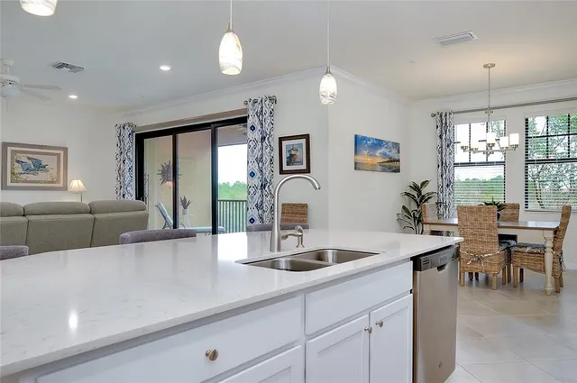 a dining room with furniture a chandelier and window