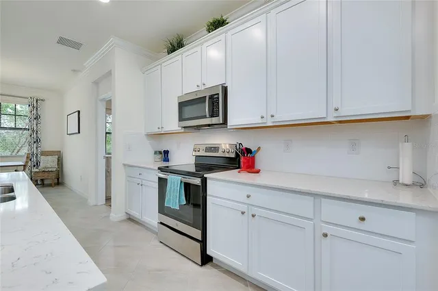 a dining room with furniture and potted plants