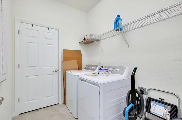 a dining hall with stainless steel appliances kitchen island granite countertop a table chairs and a view of living room