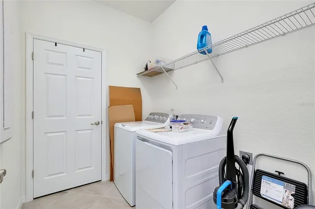 a dining hall with stainless steel appliances kitchen island granite countertop a table chairs and a view of living room