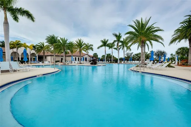 an aerial view of a swimming pool patio and outdoor seating