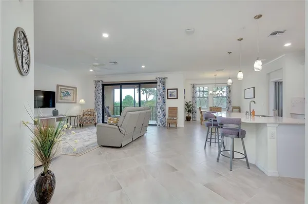 a bedroom with furniture and a flat screen tv