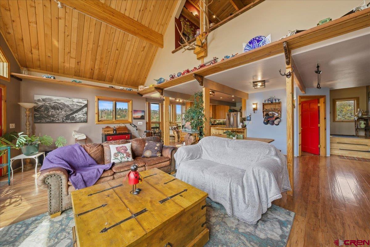 87 Which Way Ridgway, CO 81432 - Photo 20 of 45 a living room filled with furniture and a chandelier