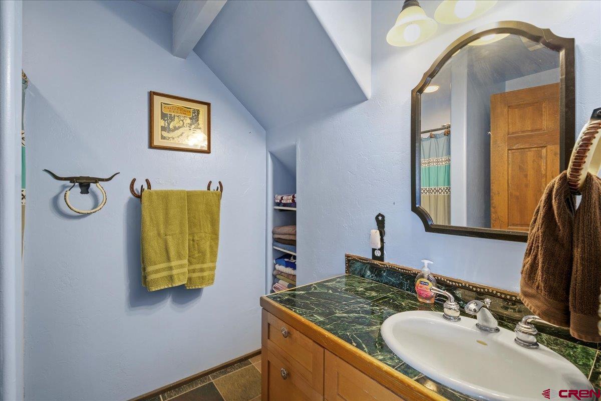 87 Which Way Ridgway, CO 81432 - Photo 40 of 45 a bathroom with a granite countertop sink and a mirror