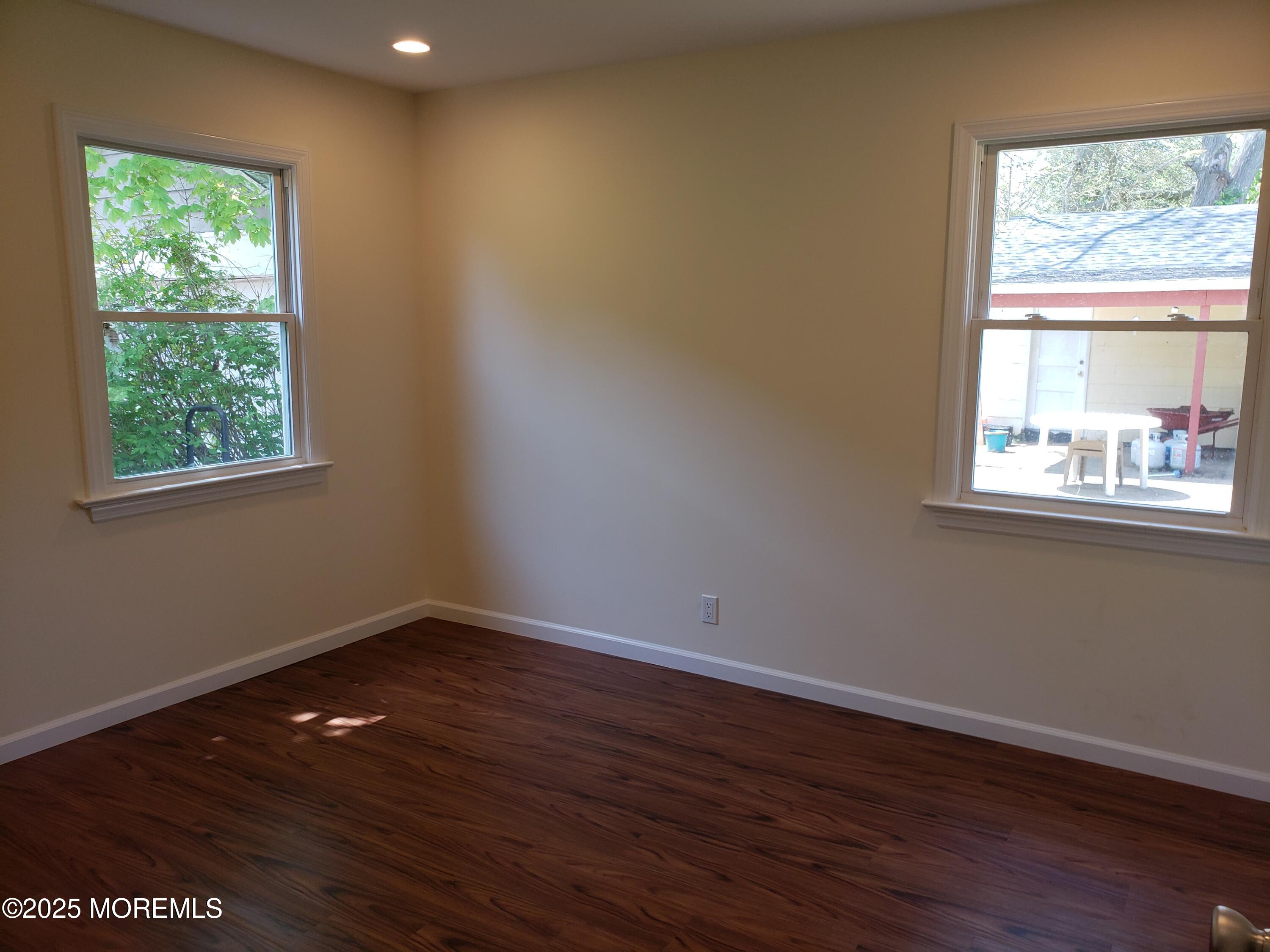 158 Monmouth Road Oakhurst, NJ 07755 - Photo 13 of 19 a view of an empty room with wooden floor and a window