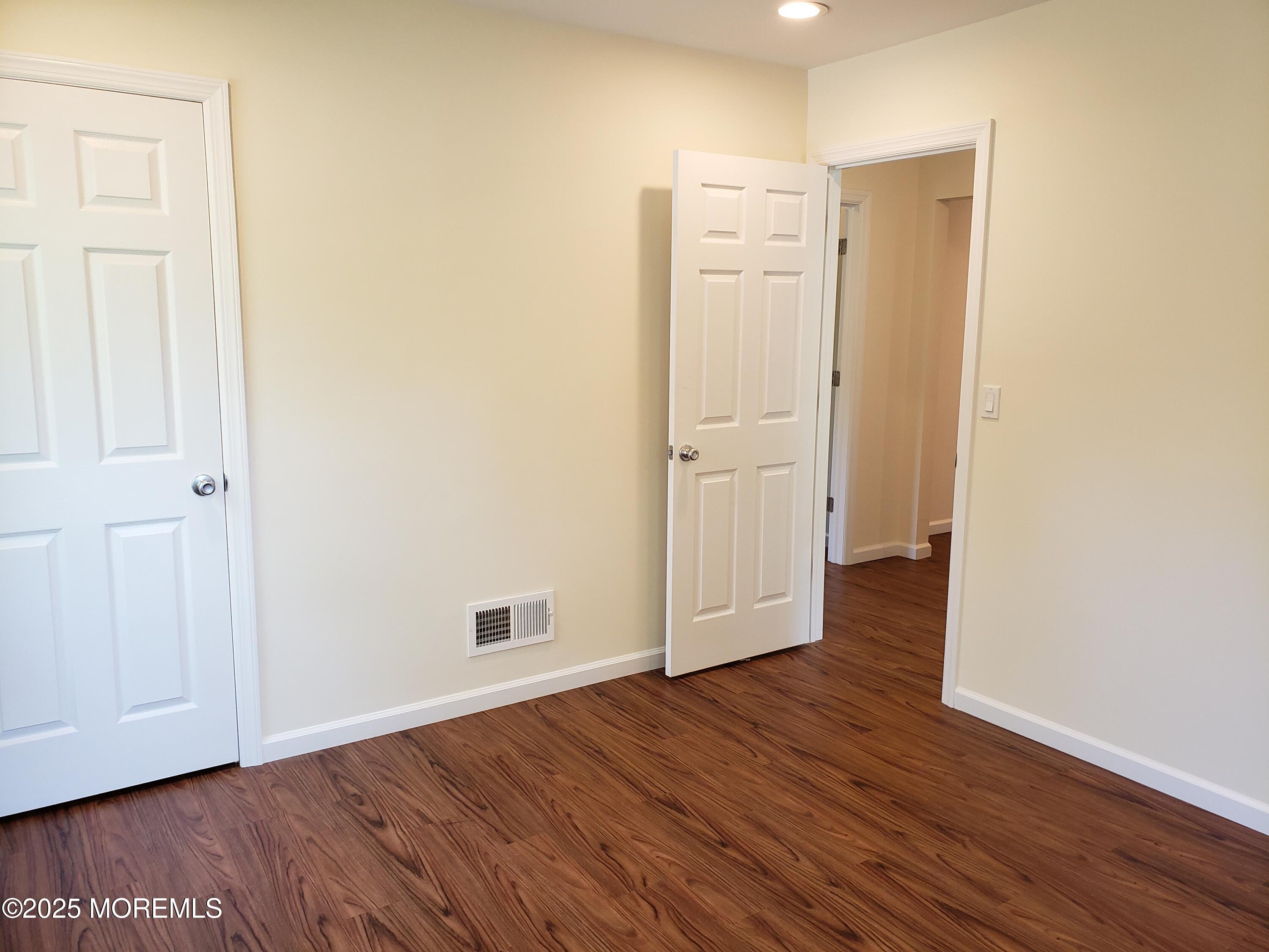 158 Monmouth Road Oakhurst, NJ 07755 - Photo 14 of 19 an empty room with wooden floor