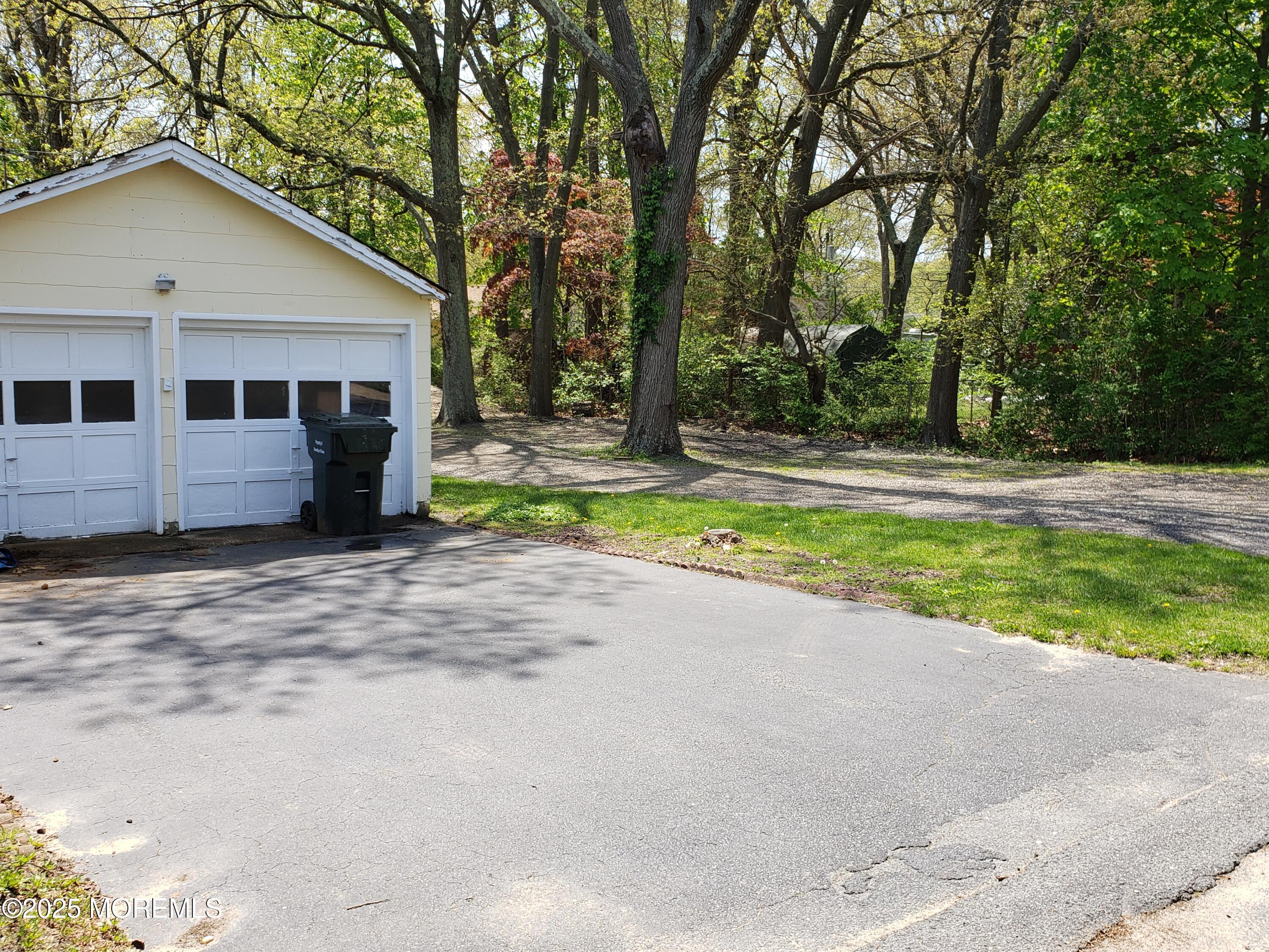 158 Monmouth Road Oakhurst, NJ 07755 - Photo 19 of 19 a view of a house with backyard and trees