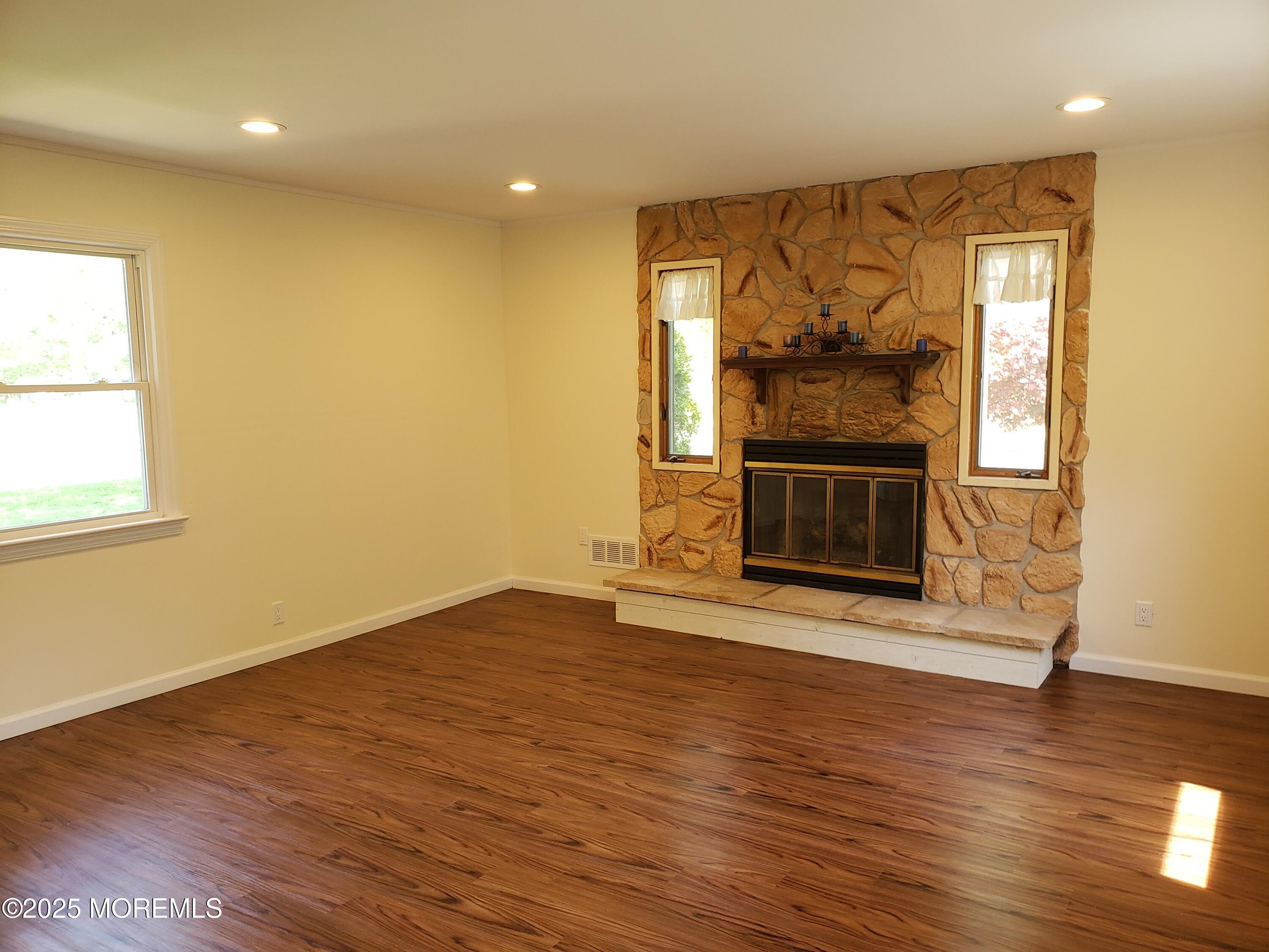 158 Monmouth Road Oakhurst, NJ 07755 - Photo 2 of 19 a view of an empty room with wooden floor and a window