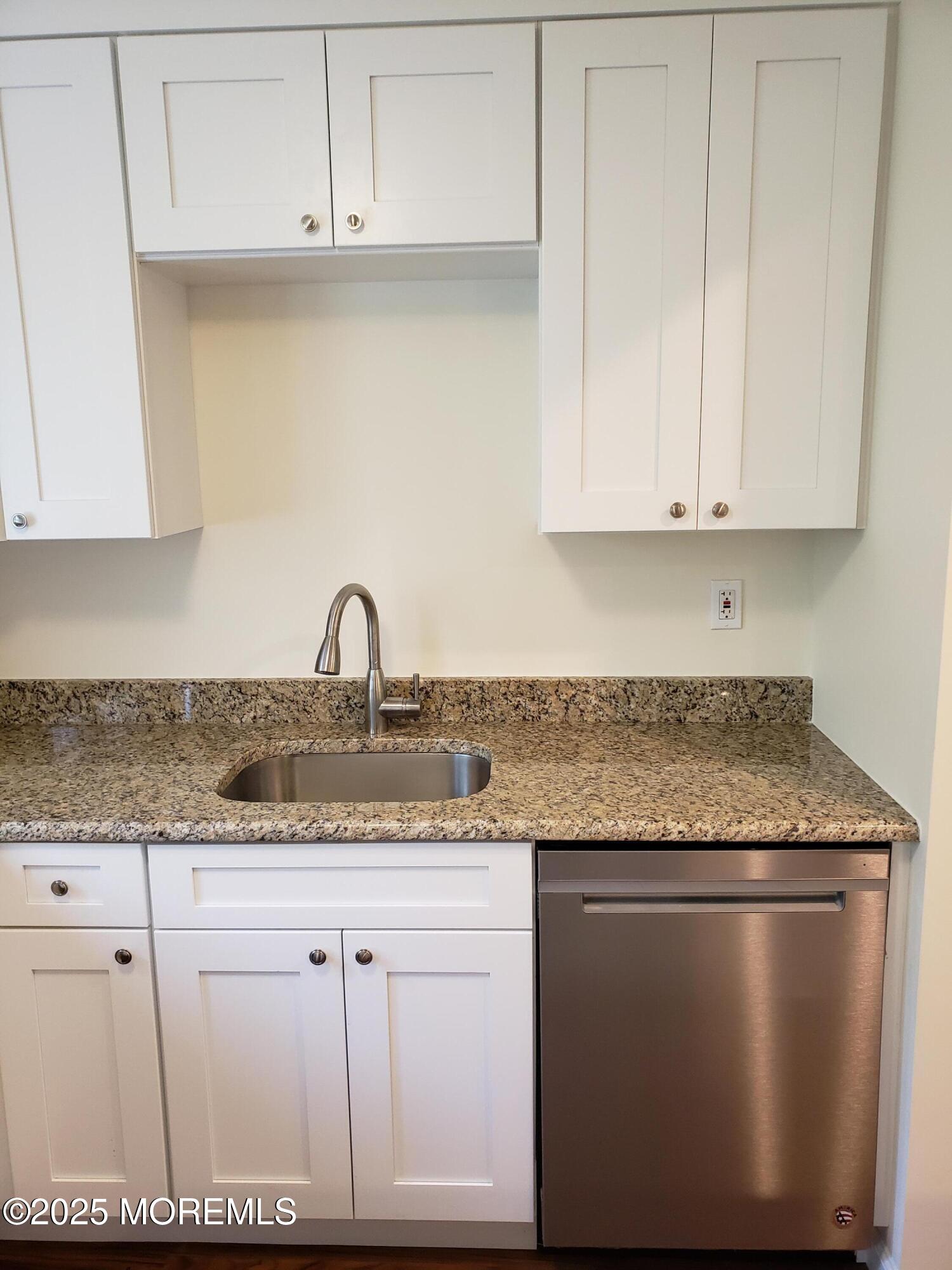 158 Monmouth Road Oakhurst, NJ 07755 - Photo 6 of 19 a kitchen with granite countertop white cabinets and a sink