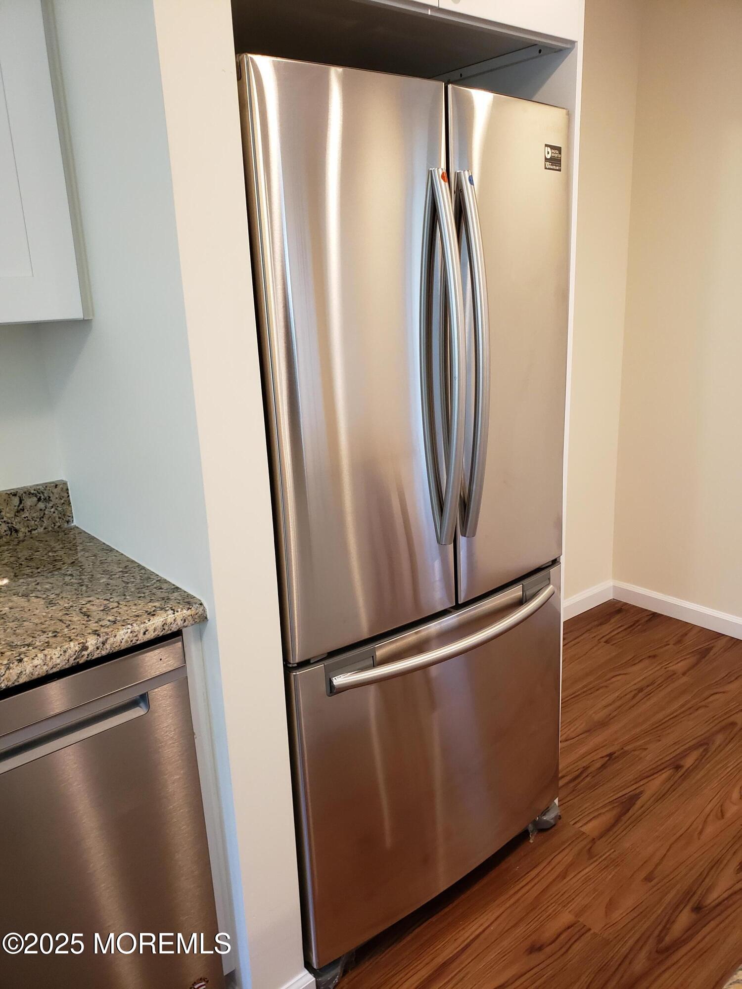 158 Monmouth Road Oakhurst, NJ 07755 - Photo 7 of 19 a view of a refrigerator in kitchen and wooden floor
