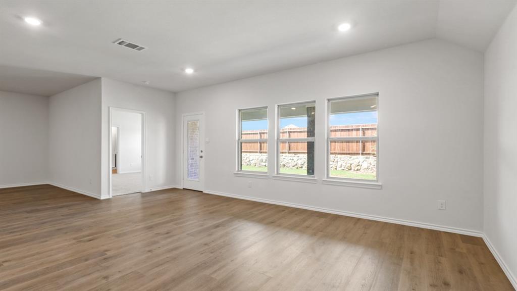 1913 Reveille Way Terrell, TX 75160 - Photo 4 of 35 Empty room with wood finished floors and recessed lighting