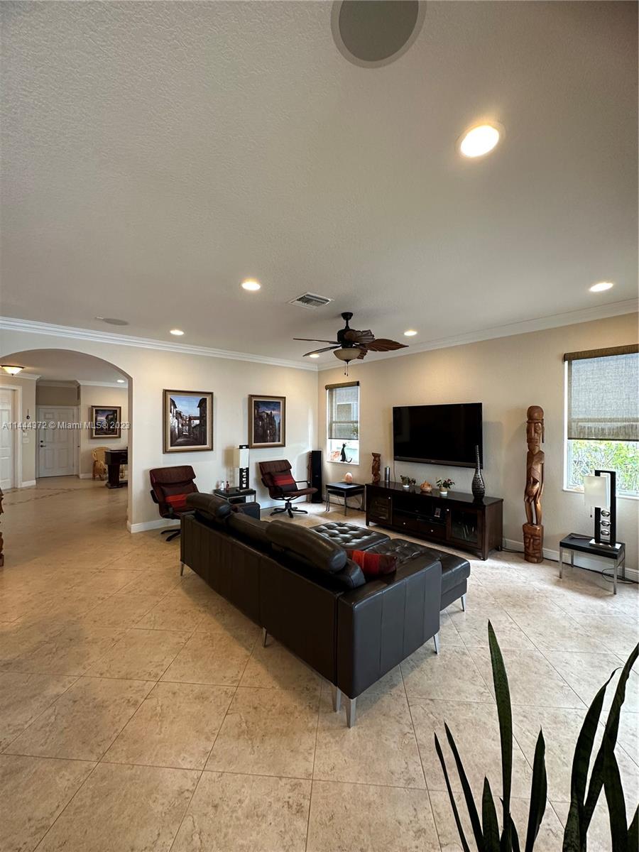 4546 Southwest 179th Way Miramar, FL 33029 - Photo 12 of 55 a living room with furniture and a flat screen tv
