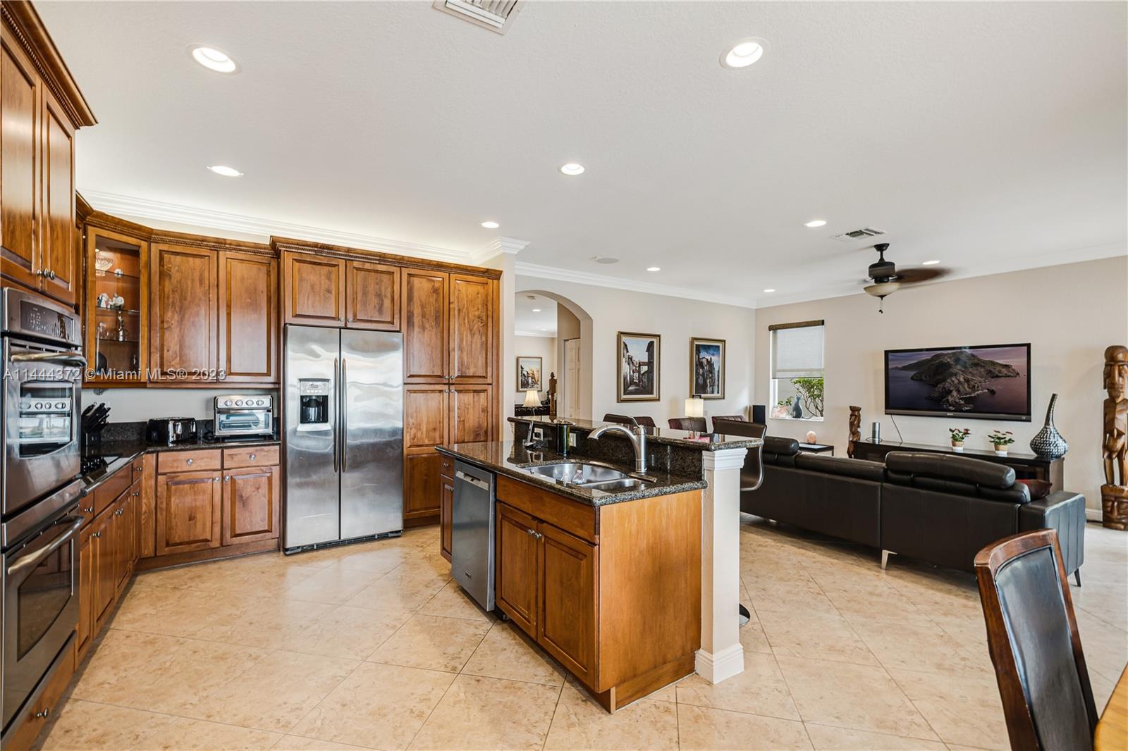 4546 Southwest 179th Way Miramar, FL 33029 - Photo 13 of 55 a kitchen with stainless steel appliances granite countertop a stove oven and a refrigerator