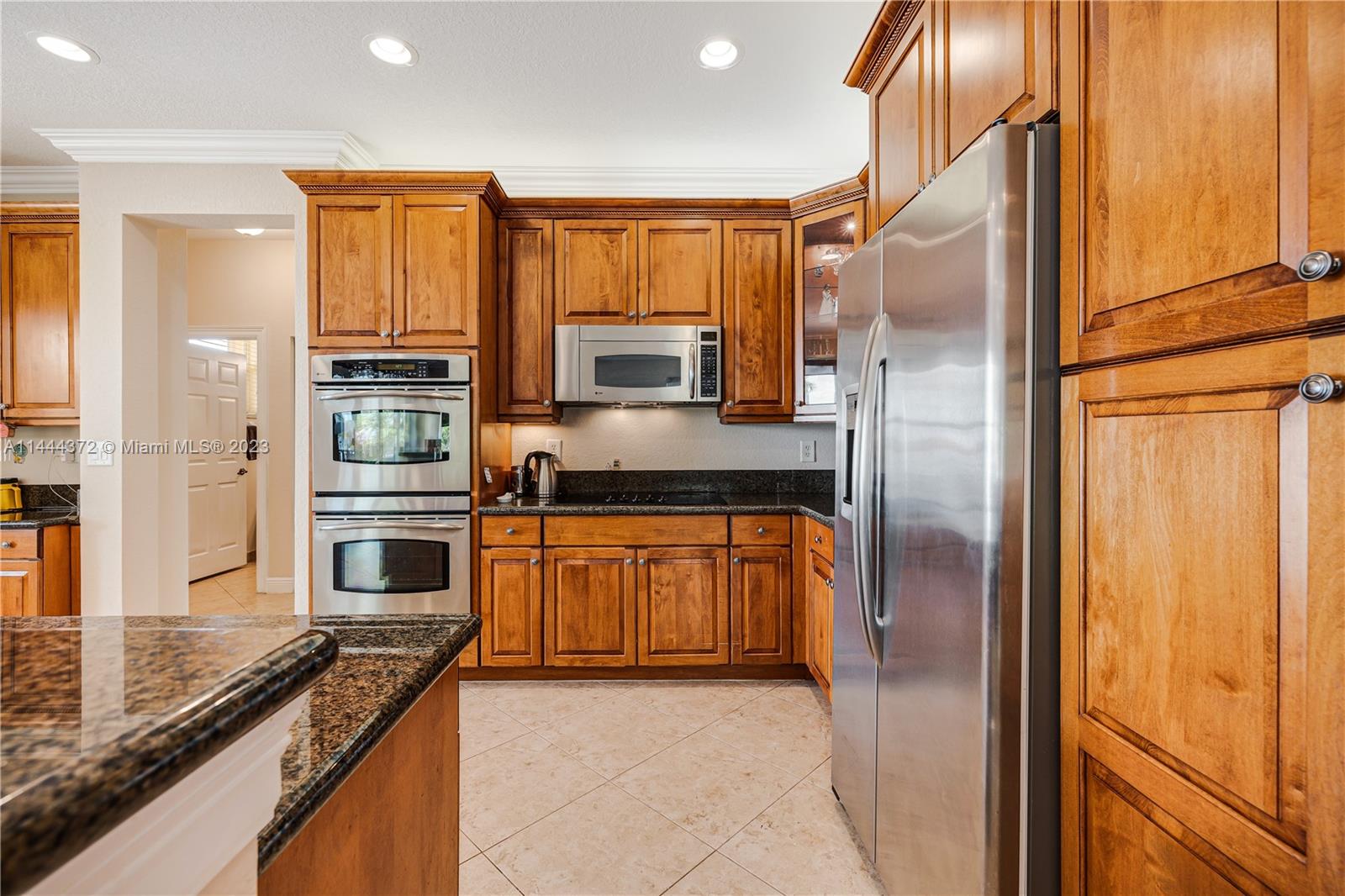 4546 Southwest 179th Way Miramar, FL 33029 - Photo 17 of 55 a kitchen with stainless steel appliances granite countertop a refrigerator and a stove