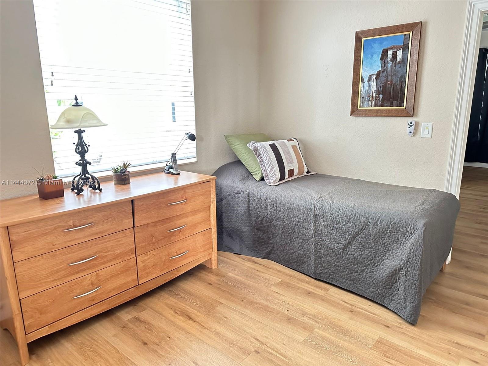 4546 Southwest 179th Way Miramar, FL 33029 - Photo 20 of 55 a bedroom with a bed and a dresser