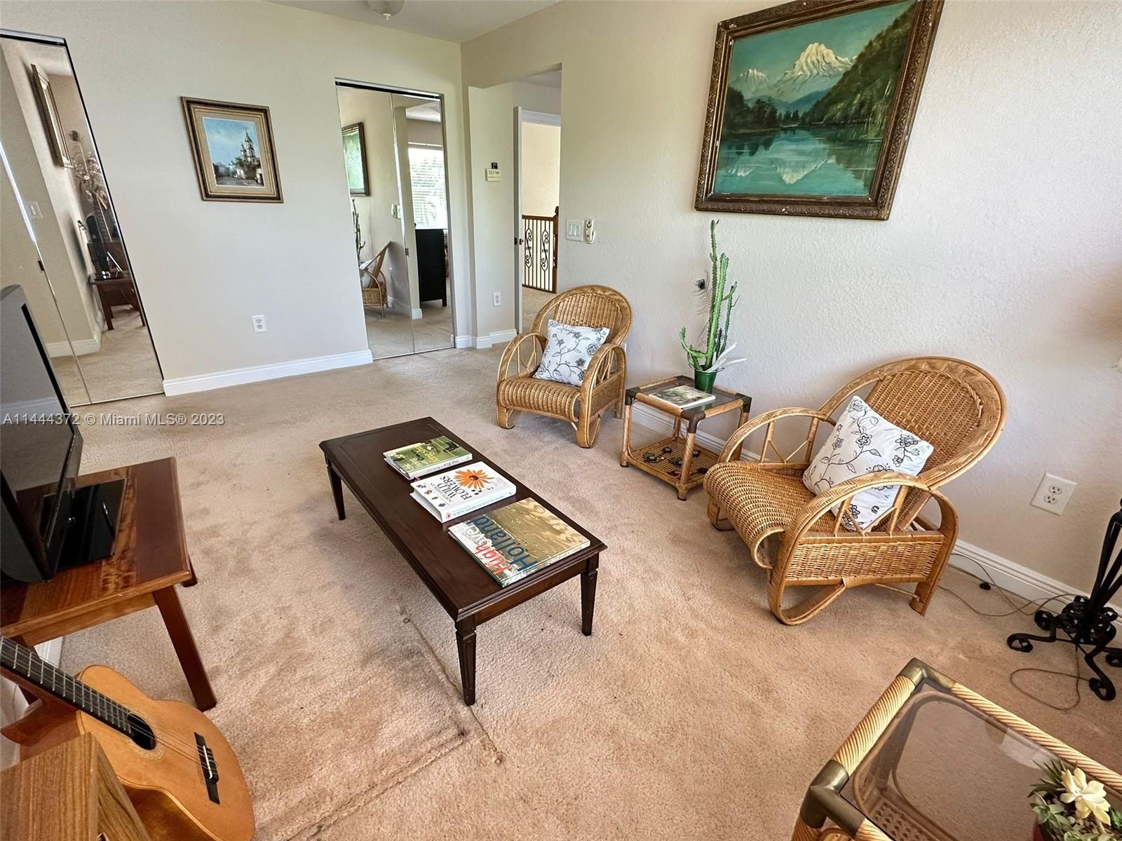 4546 Southwest 179th Way Miramar, FL 33029 - Photo 30 of 55 a living room with furniture and a mirror