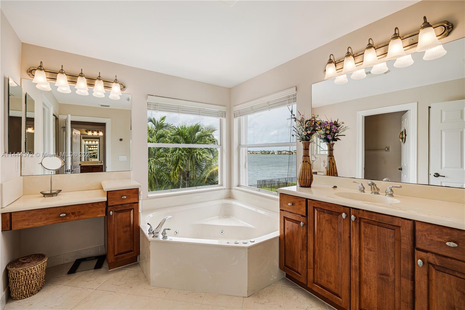 4546 Southwest 179th Way Miramar, FL 33029 - Photo 31 of 55 a spacious bathroom with a tub a double vanity sink a mirror and a bathtub