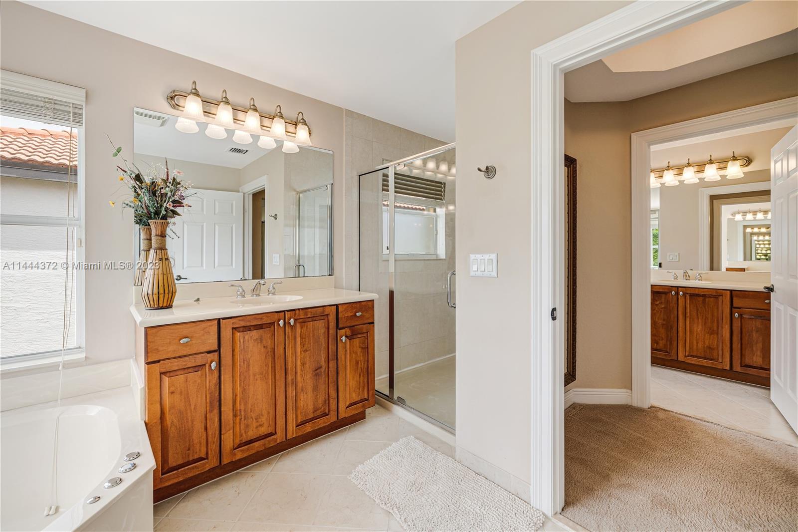 4546 Southwest 179th Way Miramar, FL 33029 - Photo 33 of 55 a bathroom with a double vanity sink and a mirror