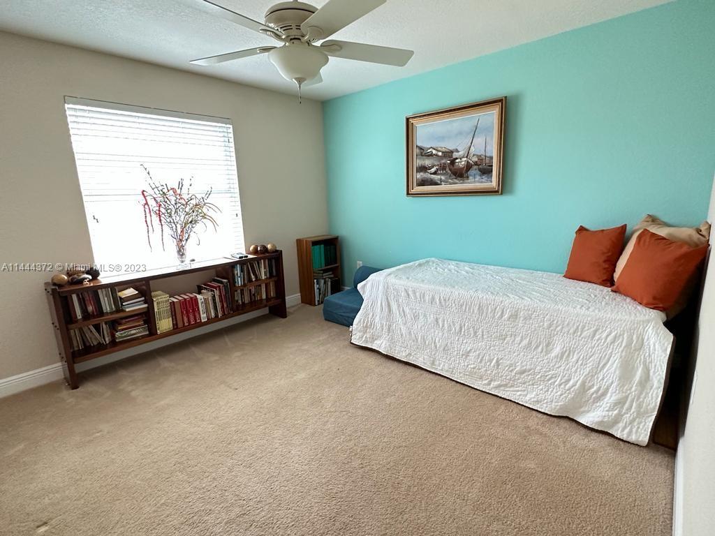 4546 Southwest 179th Way Miramar, FL 33029 - Photo 35 of 55 a bedroom with a bed and a painting on the wall