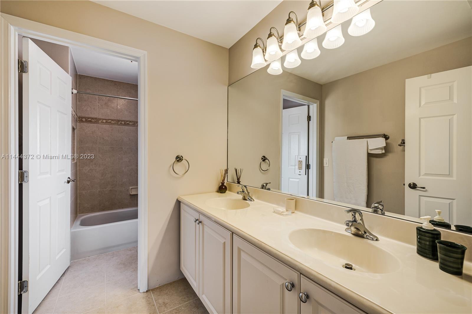 4546 Southwest 179th Way Miramar, FL 33029 - Photo 37 of 55 a bathroom with a sink double vanity granite tub and a mirror