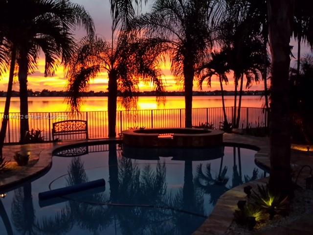 4546 Southwest 179th Way Miramar, FL 33029 - Photo 50 of 55 a view of a swimming pool with a table and chairs