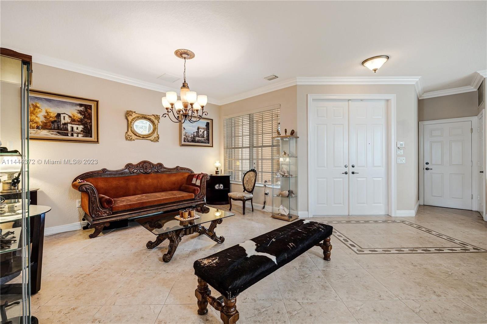4546 Southwest 179th Way Miramar, FL 33029 - Photo 6 of 55 a living room with furniture a table and a chandelier
