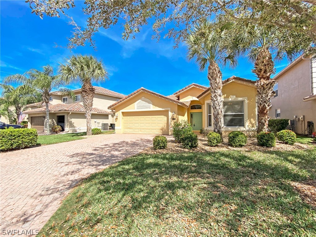 20599 Ardore Lane Estero, FL 33928 - Photo 1 of 29 a front view of a house with a yard
