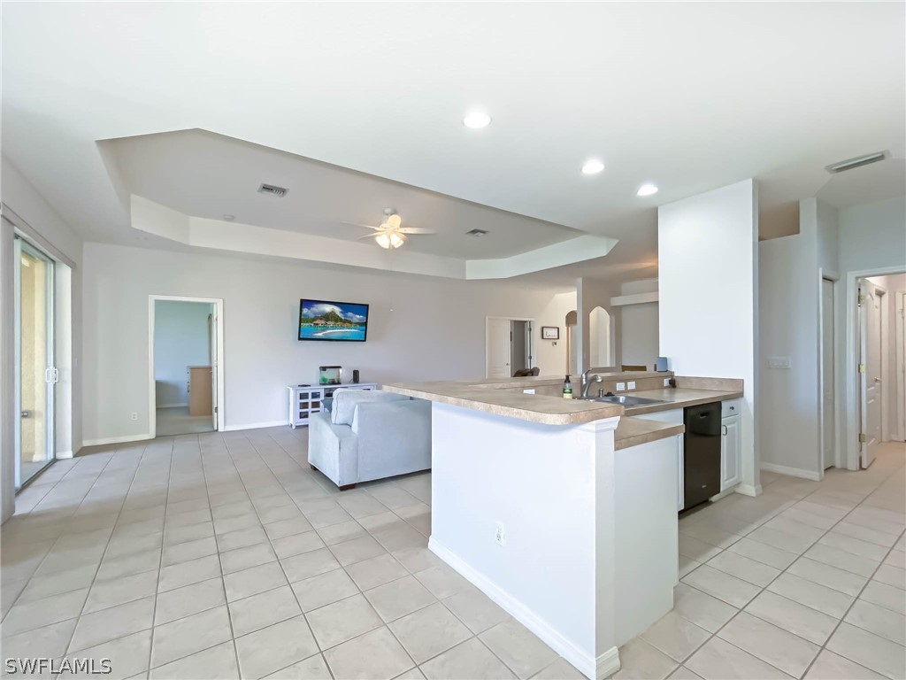 20599 Ardore Lane Estero, FL 33928 - Photo 11 of 29 a kitchen with a sink and refrigerator