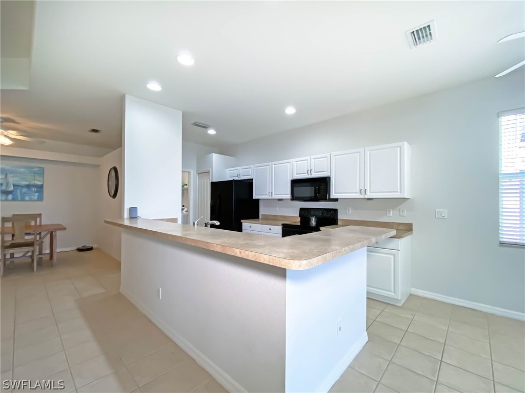 20599 Ardore Lane Estero, FL 33928 - Photo 12 of 29 a kitchen with stainless steel appliances a sink stove and microwave